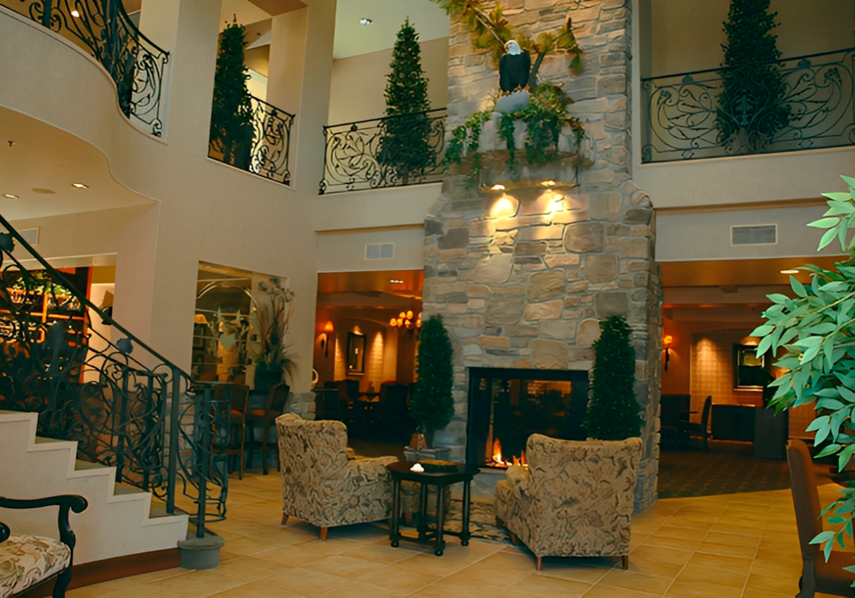 Hotel lobby with fireplace and seating area.
